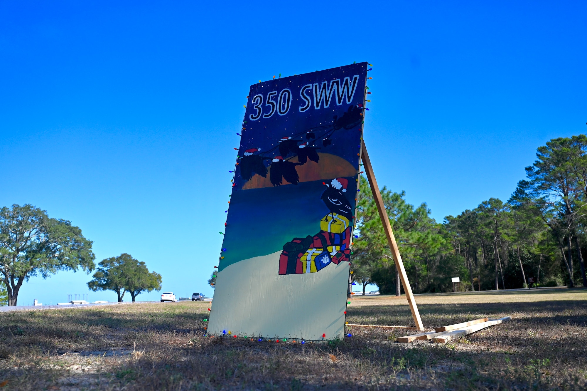 The 350th Spectrum Warfare Wing's holiday greeting card is presented on Eglin Boulevard at Eglin Air Force Base, Fla., Dec. 2, 2022. This is the 350th SWW's first year participating in the Eglin Annual Holiday Greeting Card Competition (U.S. Air Force photo by 1st Lt. Benjamin Aronson)