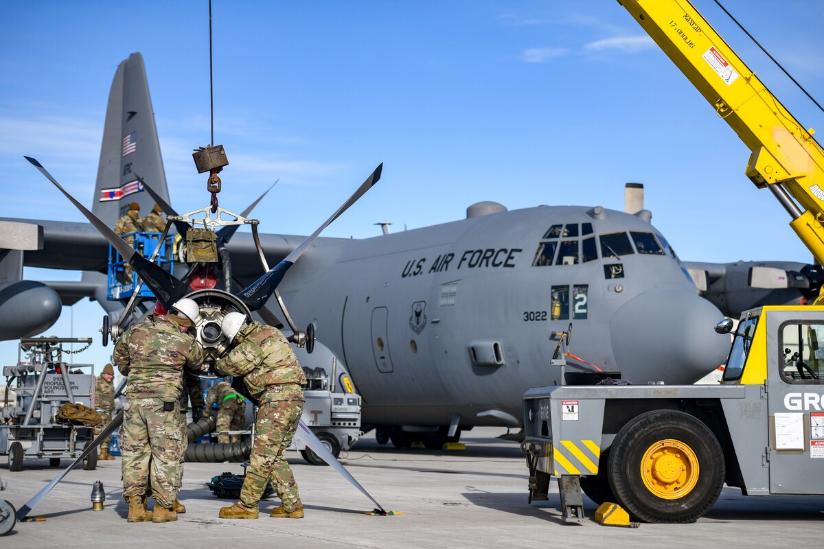 Aerospace propulsion technicians assigned to the 910th Aircraft Maintenance Squadron prepare a defective propeller for transport while others install a new propeller onto a 910th Airlift Wing C-130H Hercules aircraft, Jan. 17, 2023, at Mountain Home Air Force Base, Idaho.