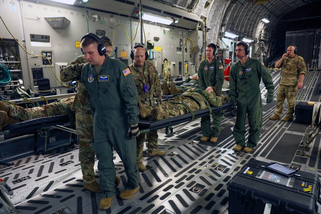 Image of a group of Airmen carrying a patient during training.