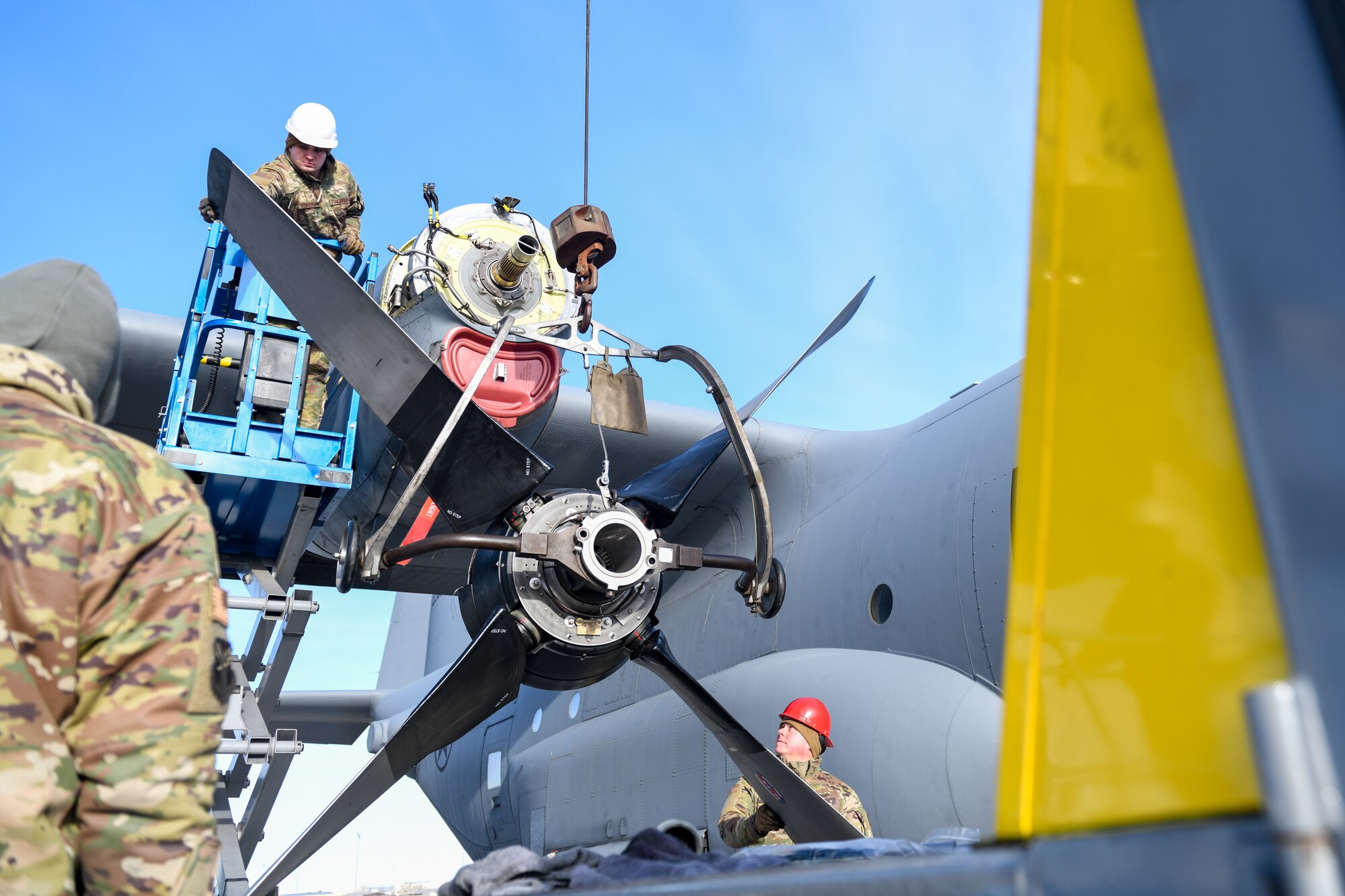 Aerospace propulsion technicians assigned to the 910th Aircraft Maintenance Squadron raise a propeller into position for installation onto a 910th Airlift Wing C-130H Hercules aircraft, Jan. 17, 2023, at Mountain Home Air Force Base, Idaho.