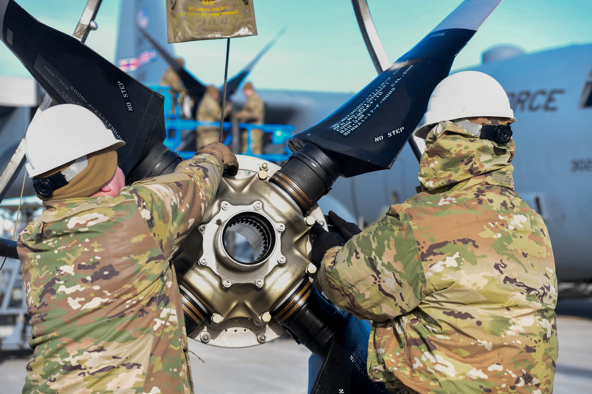 Aerospace propulsion technicians assigned to the 910th Aircraft Maintenance Squadron prepare a defective propeller for transport while others install a new propeller onto a 910th Airlift Wing C-130H Hercules aircraft, Jan. 17, 2023, at Mountain Home Air Force Base, Idaho.