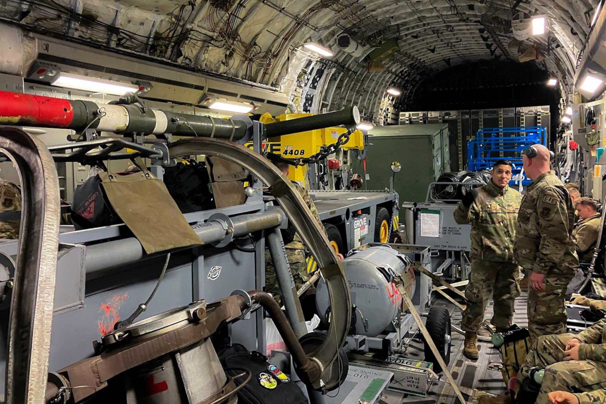 A C-17 Globemaster III aircraft from Pittsburgh Air Reserve Station, Pennsylvania, transports a maintenance recovery team dispatched by the 910th Airlift Wing, Jan. 9–20, 2023, to inspect and repair a C-130H Hercules aircraft from Youngstown Air Reserve Station, Ohio.