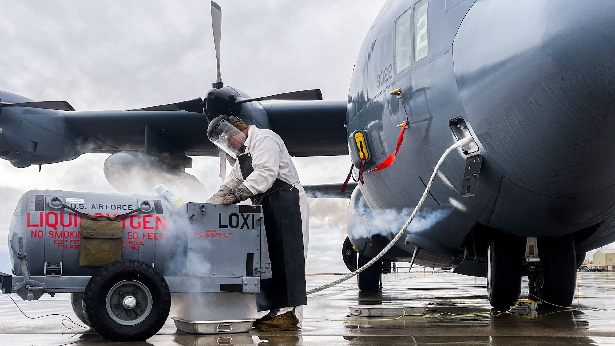 Senior Airman Anthony Ganni, an aerospace maintenance journeyman assigned to the 910th Aircraft Maintenance Squadron, services liquid oxygen on a 910th Airlift Wing C-130H Hercules aircraft on Jan. 11, 2023, at Mountain Home Air Force Base, Idaho.