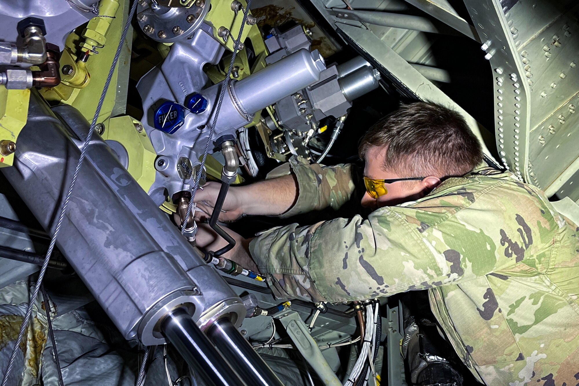 Senior Airman Chris Tancer, an avionics technician assigned to the 910th Aircraft Maintenance Squadron, services a 910th Airlift Wing C-130H Hercules aircraft, Jan. 11, 2023, at Mountain Home Air Force Base, Idaho.