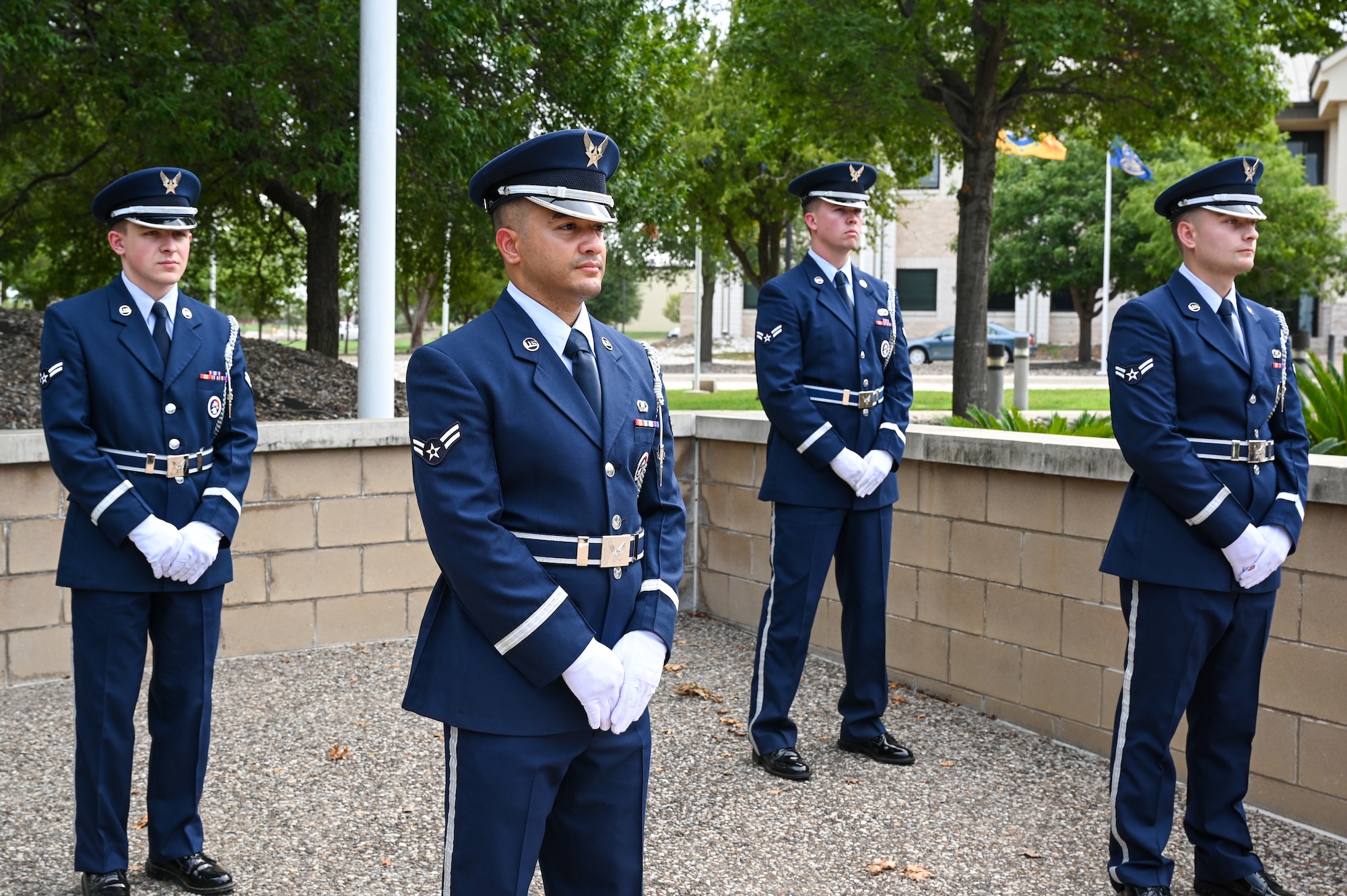 U.S. Air Force ceremonial Guardsmen await at parade rest to perform a retreat ceremony at Laughlin Air Force Base, Texas, on Sept. 9, 2022. The retreat ceremony is a solemn and meaningful tradition that pays respect to the flag and the nation it represents and honors the sacrifices of those who have defended it. (U.S. Air Force photo by Airman 1st Class Keira Rossman)