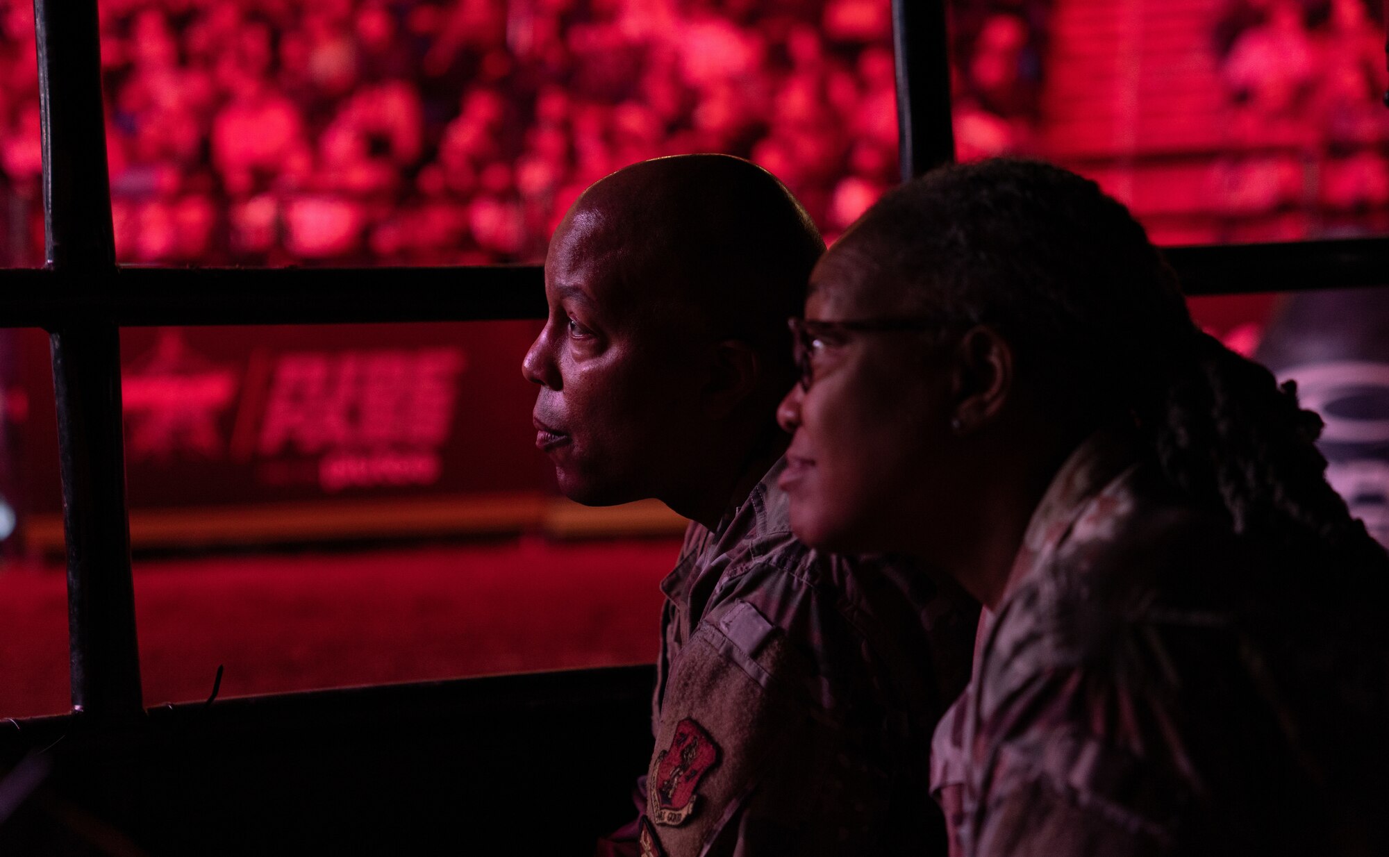 Brig. Gen. Konata Crumbly, joint staff director, Georgia National Guard, and Command Chief Master Sgt. Ga. ANG, watch from the “shark cage” at the Professional Bull Riders event “Unleash The Beast’s Gwinnett Chute Out” in Duluth, Ga., Jan. 22, 2023.