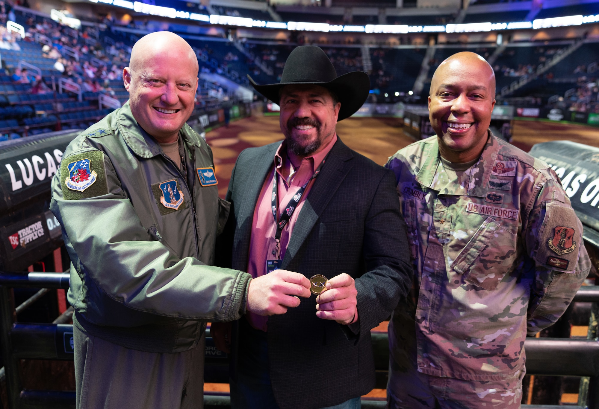 Maj. Gen. Thomas Grabowski, assistant adjutant general, Georgia National Guard and Brig. Gen. Konata Crumbly, joint staff director, Georgia National Guard, present Curtis Weske, head security manager, Professional Bull Riders, a coin at the PBR event “Unleash The Beast’s Gwinnett Chute Out” in Duluth, Ga. Jan. 22, 2023.