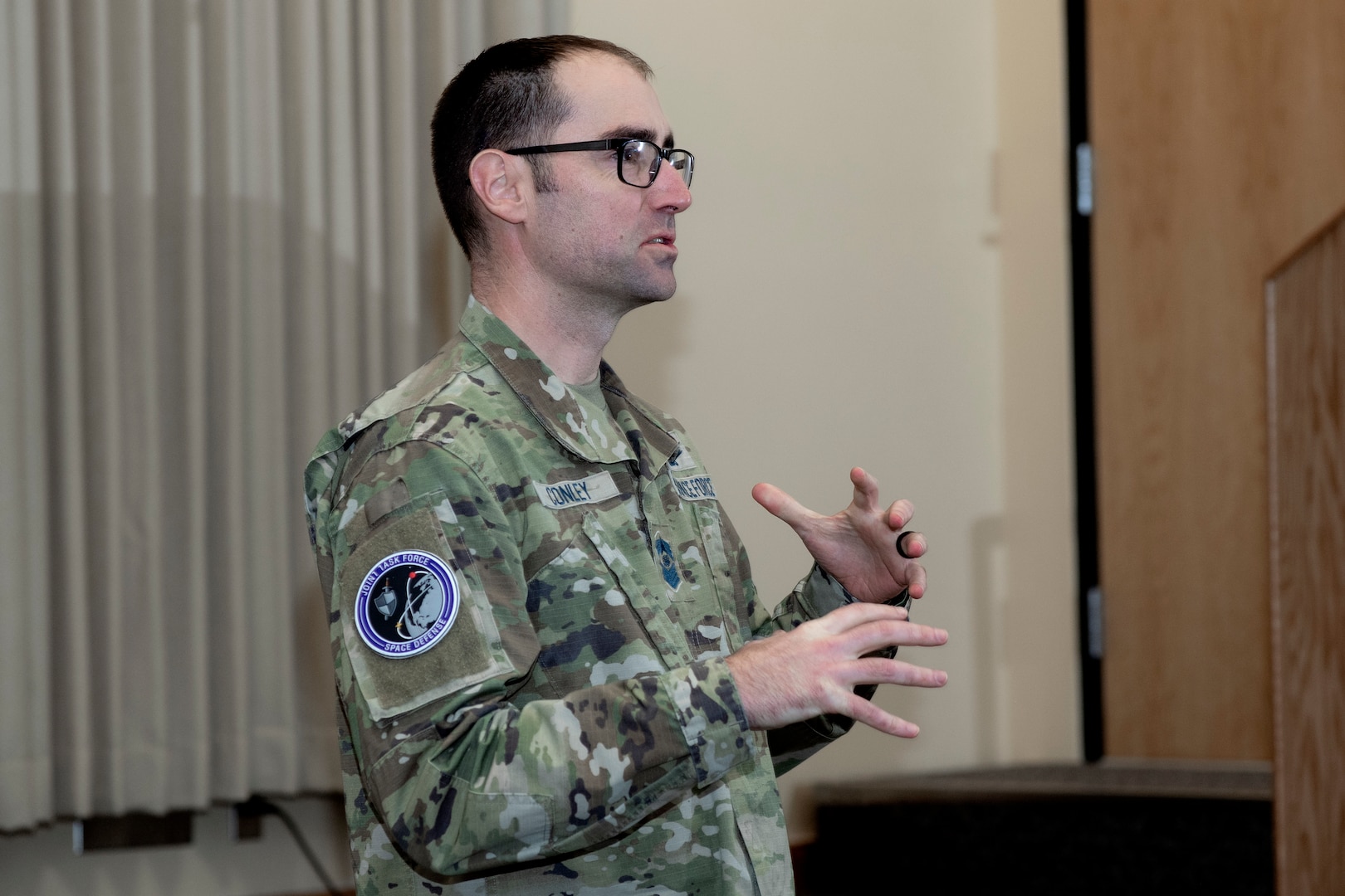 Man in uniform speaking