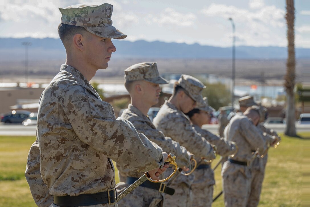 U.S. Marine Corporals with Marine Air Ground Task Force Training Command, Marine Corps Air Ground Combat Center (MCAGCC), practice sword manual while attending Corporals Course 1-23 at MCAGCC, Twentynine Palms, California, Jan. 17, 2023. Corporals Course trains Marines to better lead Marines underneath them and prepare them for promotion to Sergeant. (U.S. Marine Corps Photo by Lance Cpl. Anna Higman)