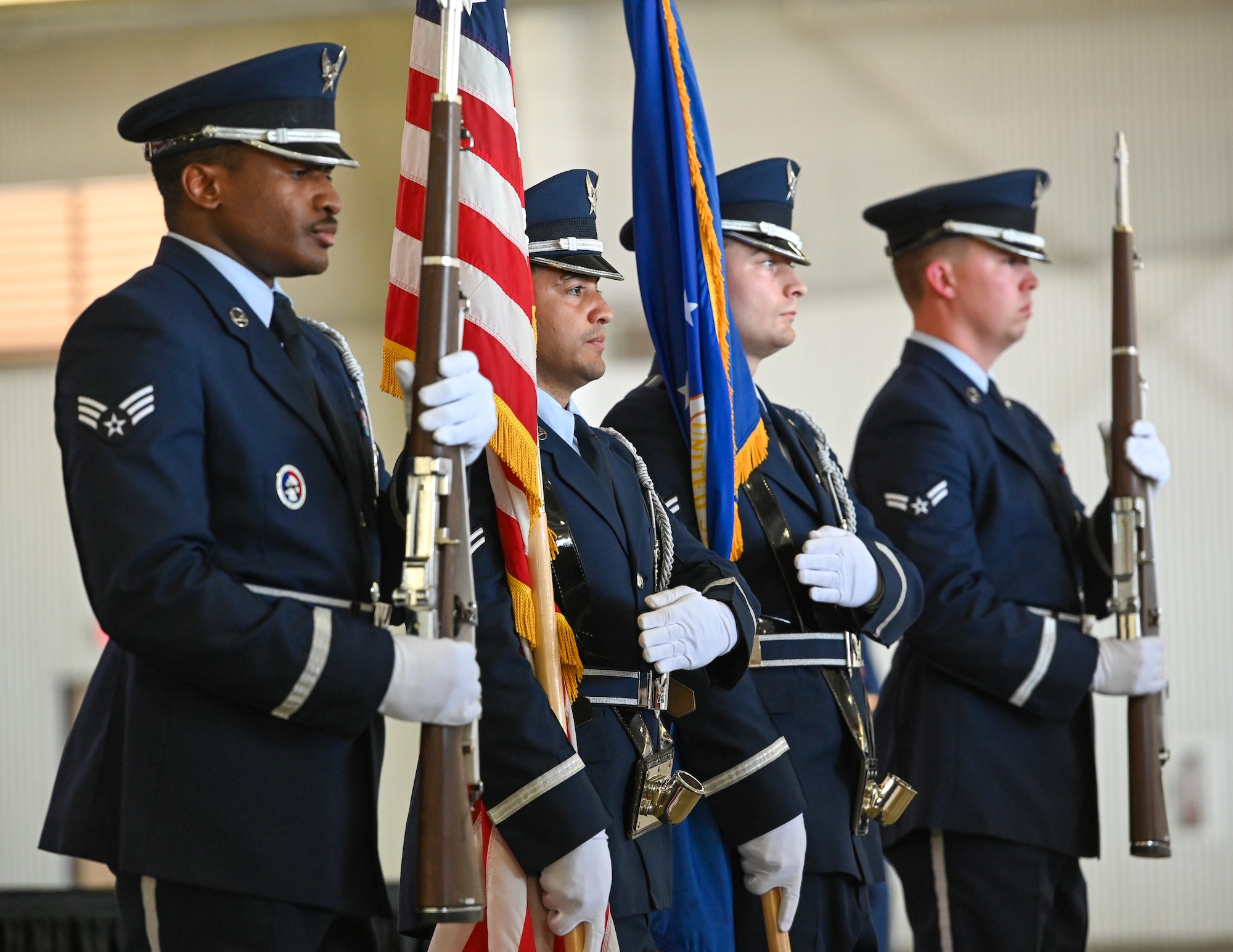 U.S. Air Force ceremonial Guardsmen perform a color detail for a retirement ceremony at Laughlin Air Force Base, Texas, on July 7, 2022. When presenting the Colors, the Laughlin Base Honor Guard team aims to showcase the pride and respect that the Air Force has for the American flag and the nation it represents. (U.S. Air Force photo by Airman 1st Class Keira Rossman)