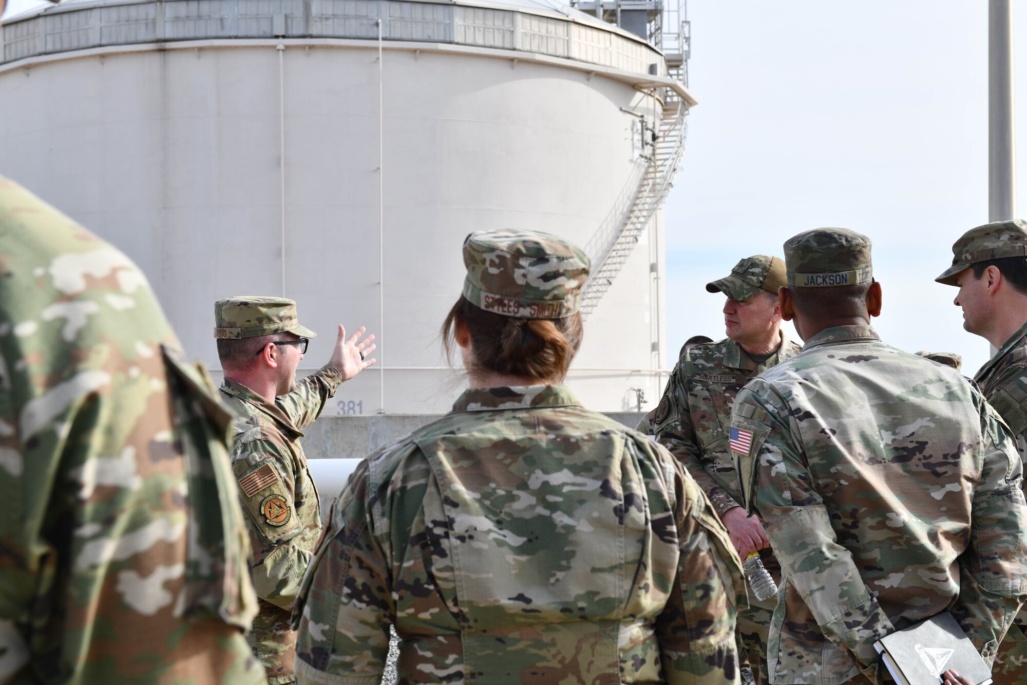 U.S. Air Force Master Sgt. Dylan King, 97th Logistics Readiness Squadron fuels information service center section chief, presents a petrol tank to Brig. Gen. Brian Hartless, Air Force director of engineers, Col. Marcus Jackson, Buckley Space Force Base commander, and Chief Master Sgt. Adrienne Warren 32nd Air Expeditionary Wing command chief at Altus Air Force Base, Oklahoma, Jan. 19, 2022. The 97th Logistics Readiness Squadron's fuels flight enables a flying mission that boasts the world's busiest heavy traffic pattern, its busiest night-vision goggle assault runway, the most "touch-and-go" landings and more in-air refueling contacts than anywhere else in the world. (U.S. Air Force photo by Airman 1st Class Miyah Gray)