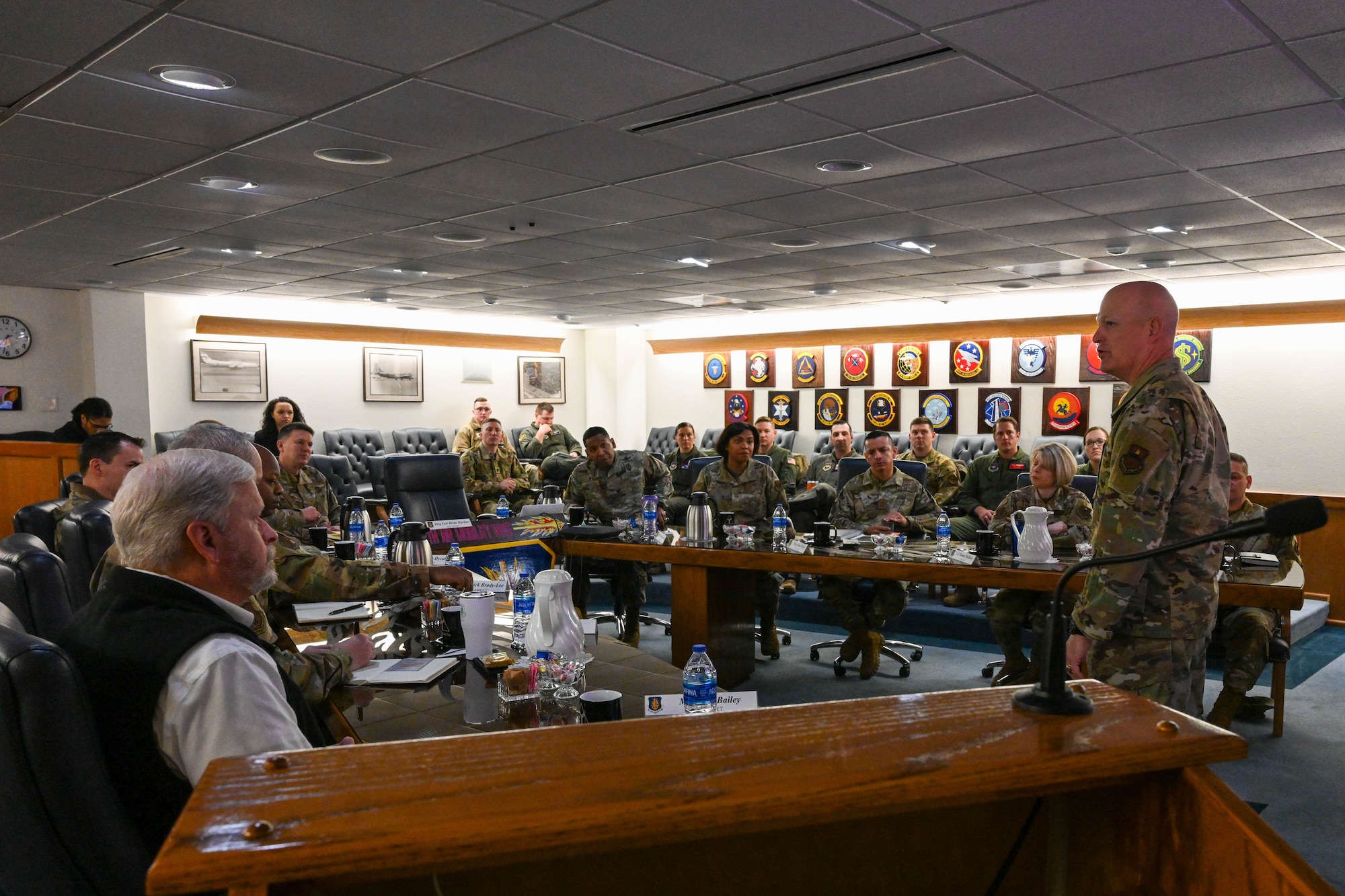 U.S. Air Force Col. Blaine Baker, 97th Air Mobility Wing commander, addresses wing leaders and the Commander in Chief Installation Excellence Award evaluation team in the wing conference room at Altus Air Force Base, Oklahoma, Jan. 19, 2023. During the visit, base leaders portrayed the installation as "the little engine that could" and as a unit that "punches well above their weight class" in regards to resource utilization and mission execution. (U.S. Air Force photo by Senior Airman Trenton Jancze)