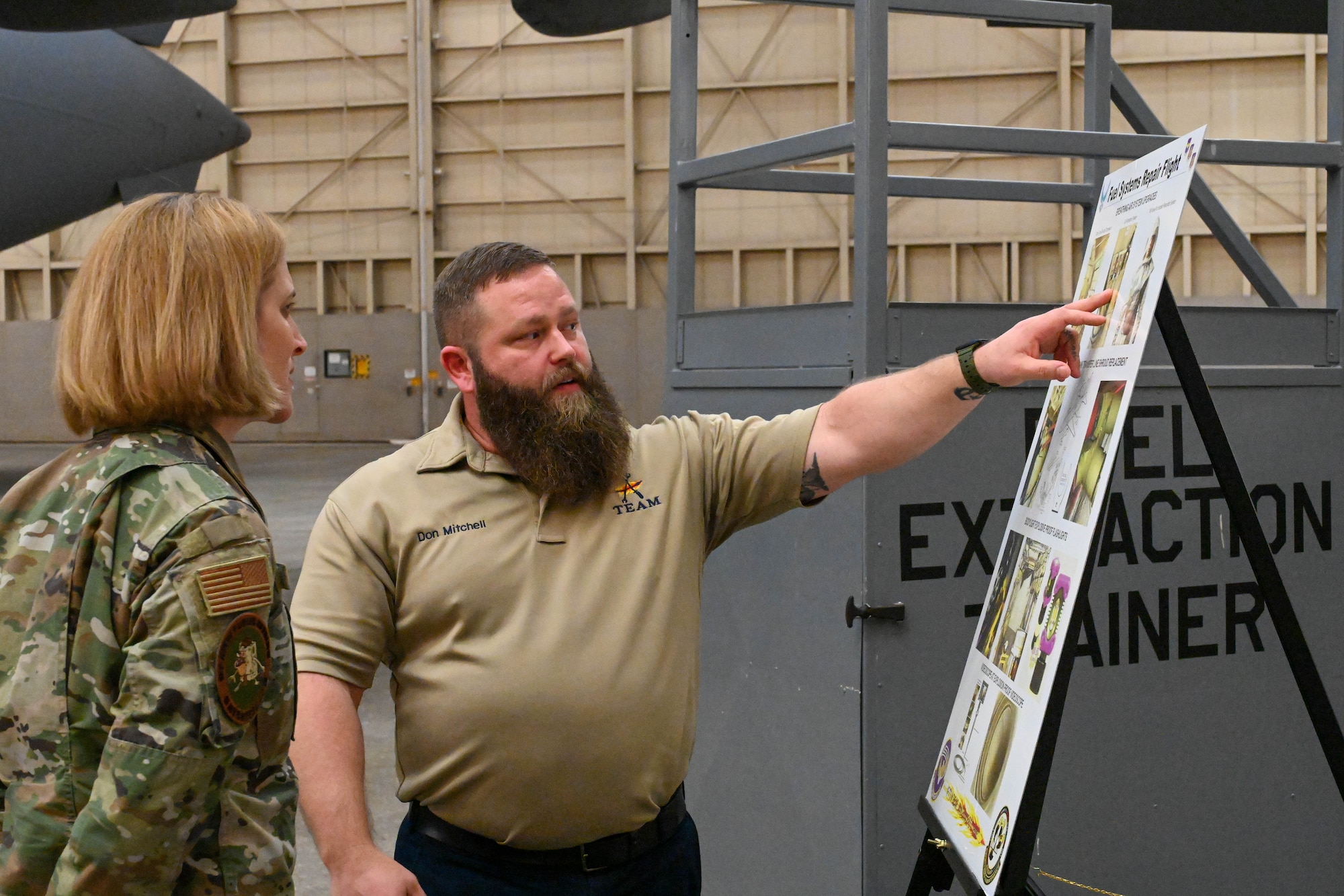 Don Mitchell, 97th Maintenance Squadron fuel systems flight chief, gives a presentation to U.S. Air Force Col. Catherine Barrington, 90th Missile Wing commander, at Altus Air Force Base, Oklahoma, Jan. 19, 2023. The 97th MXS is comprised of five flights that provide on-and-off equipment aircraft and component maintenance to ensure safe, reliable aircraft for the 97th Air Mobility Wing’s 43 aircraft. (U.S. Air Force photo by Senior Airman Trenton Jancze)