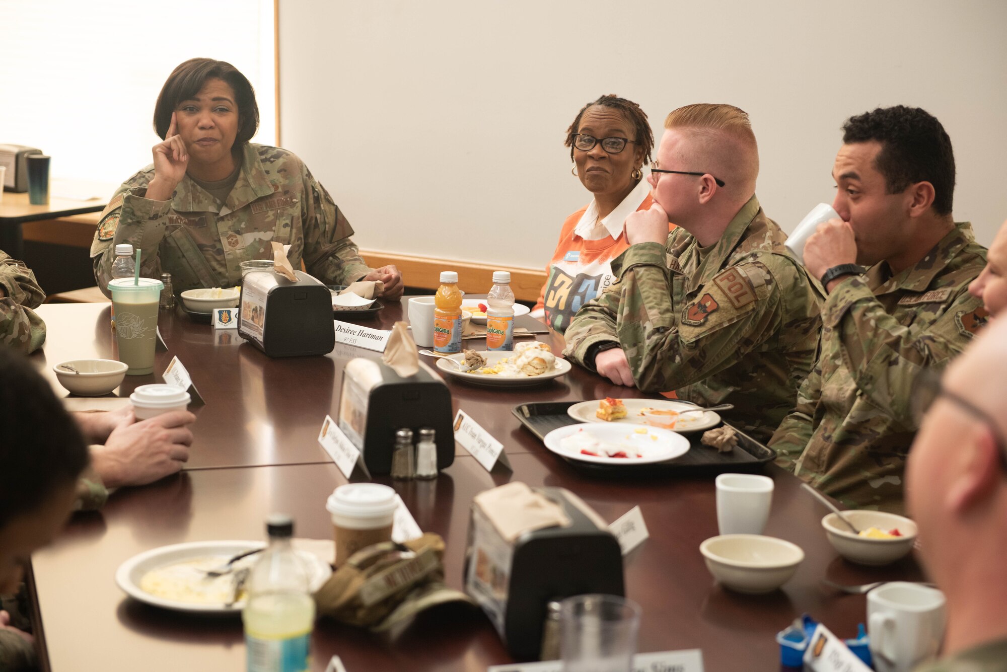 U.S. Air Force Chief Master Sgt. Adrienne Warren, 432nd Air Expeditionary Wing command chief, listens to 97th Air Mobility Wing Airmen at a breakfast at Altus Air Force Base, Oklahoma, Jan. 20, 2023. Base leaders chose to show Warren facilities like the Child Development Center and the Military and Family Readiness center to demonstrate their dedication to creating a base where families can thrive. (U.S. Air Force photo by 2nd Lt. Charlie Nichols)
