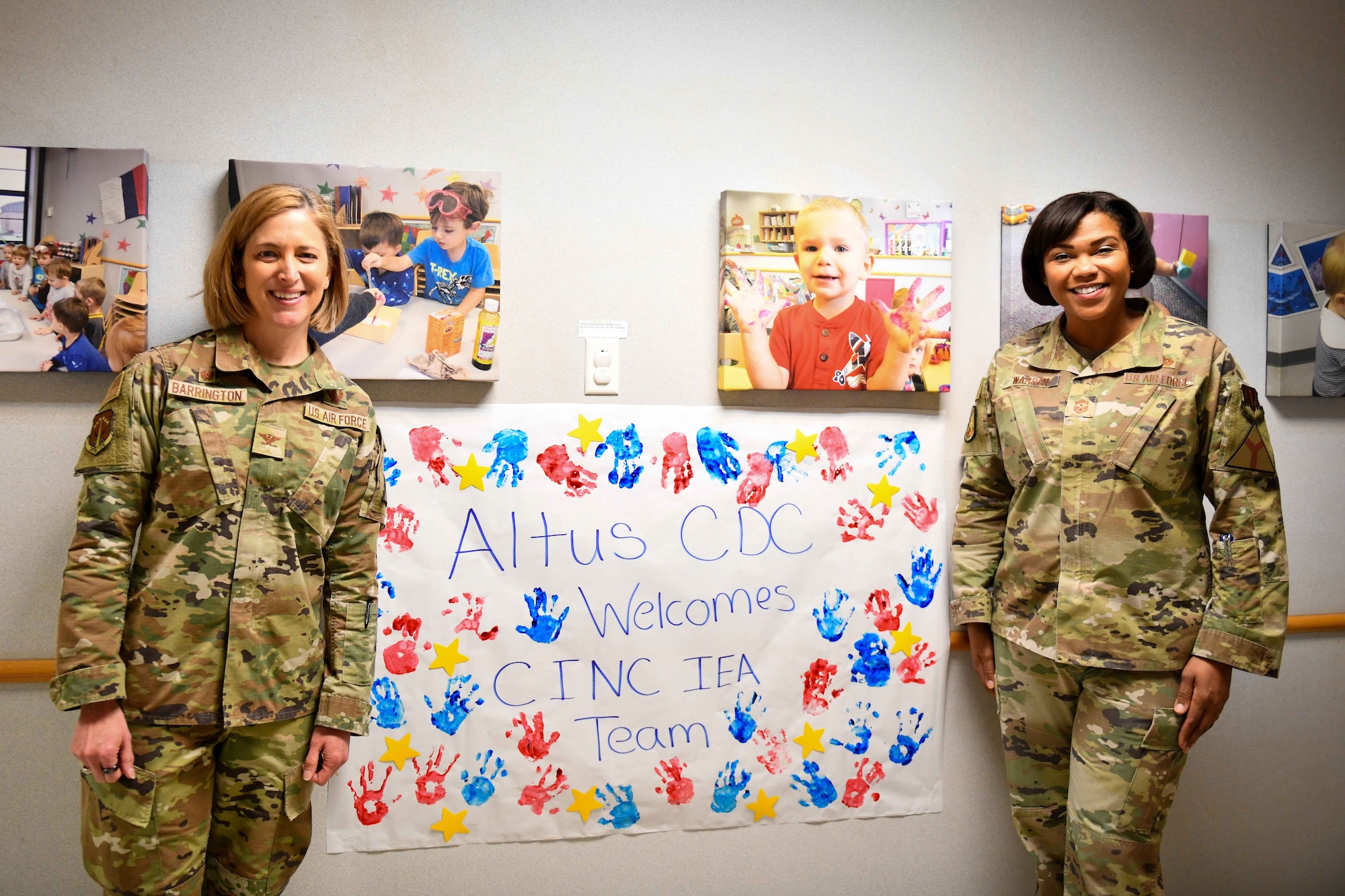 Col. Catherine Barrington, 90th Missile Wing commander and Chief Master Sgt. Adrienne Warren, 32nd Air Expeditionary Wing command chief, pose in front of a sign in the child development center (CDC) at Altus Air Force Base, Oklahoma, Jan. 20, 2023. Karrie Garrett, 97th Force Support Squadron CDC director, gave Barrington and Warren a full tour of the facility. (U.S. Air Force photo by Airman 1st Class Kari Degraffenreed)