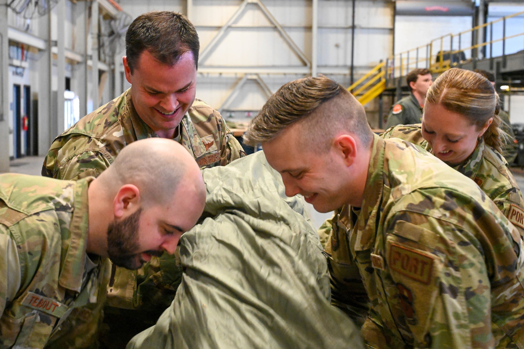 U.S. Air Force Col. Chesley Dycus, 92nd Air Refueling Wing commander, helps load a parachute at the “rigging barn” at Altus Air Force Base, Oklahoma, Jan. 20, 2023. The 97th Logistics Readiness Squadron provides combat-ready Airmen by executing the Wing’s contingency and deployment programs supporting wartime, peacetime, and humanitarian operations. (U.S. Air Force photo by Senior Airman Trenton Jancze)