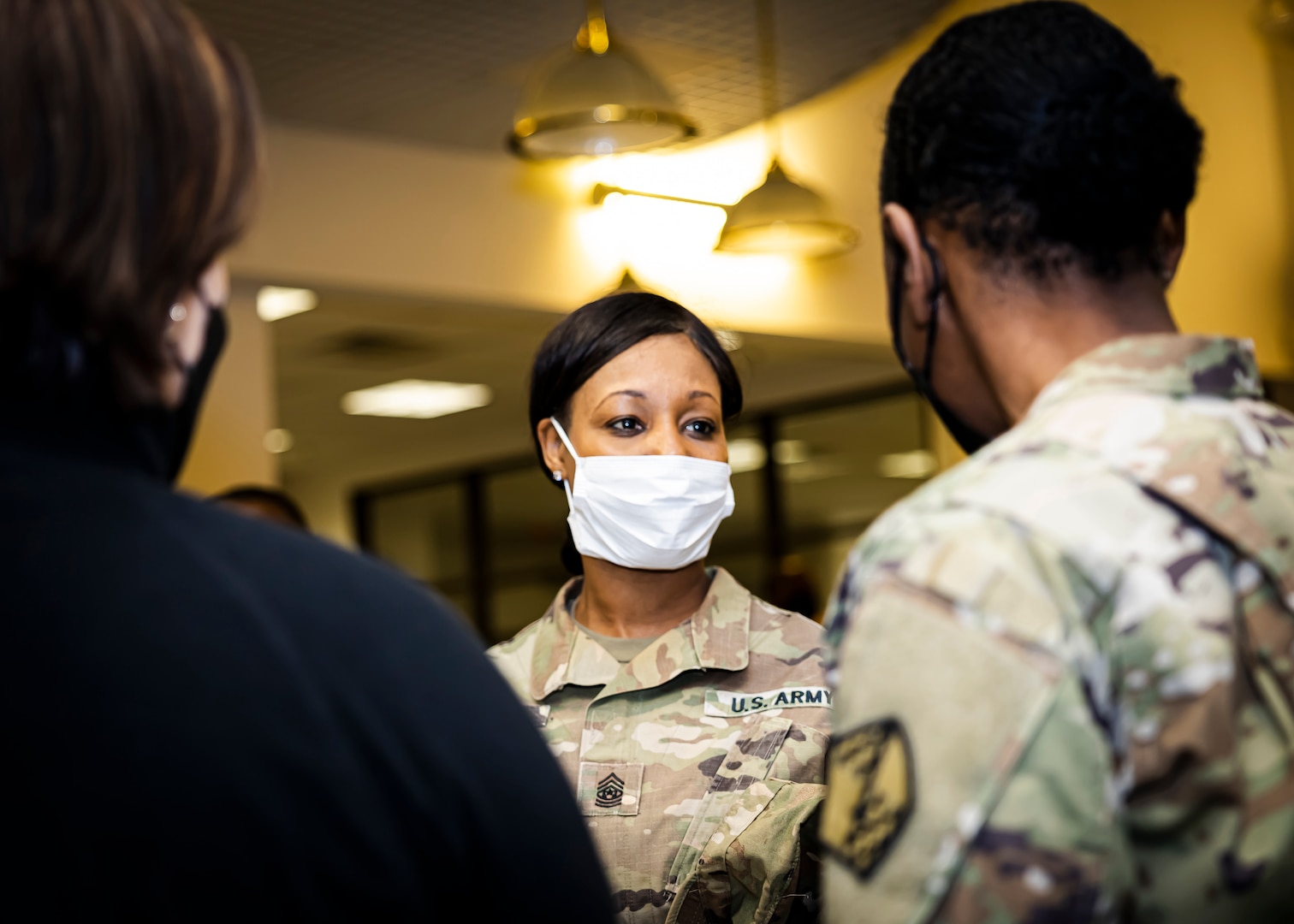 Command Sgt. Maj. Tamisha A. Love (center), Fort Lee garrison command sergeant major, talks to U.S. Army Lt. Col. Christine G. Moore (right), commander of 12th Battalion and the Baltimore Military Entrance Processing Station, and Christina Nunnery (left), the 12th executive director, Jan. 25, 2023, about Fort Lee MEPS achieving ‘MEPS of the Year’ during a celebration at Fort Lee, Va. USMEPCOM uses the ‘MEPS of the Year’ competition to improve operations and services related to core MEPS processes.(U.S. Army photo by Chad Menegay)