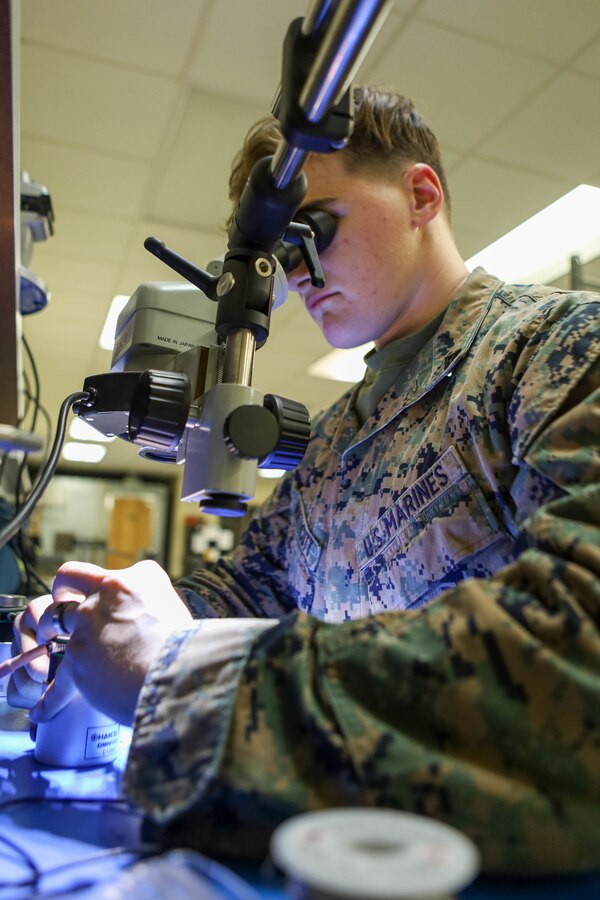 U.S. Marine Corps Lance Cpl. Matthew Northcutt, a ground radio repairer with 1st Radio Battalion, I Marine Expeditionary Force Information Group, uses a soldering iron to connect wires during a wire repair at Marine Corps Base Camp Pendleton, California, Jan. 11, 2023. Ground radio repairers’ install and repair radio equipment, including multichannel radio equipment used by ground and aviation forces. (U.S. Marine Corps photo by Cpl. Amelia Kang)