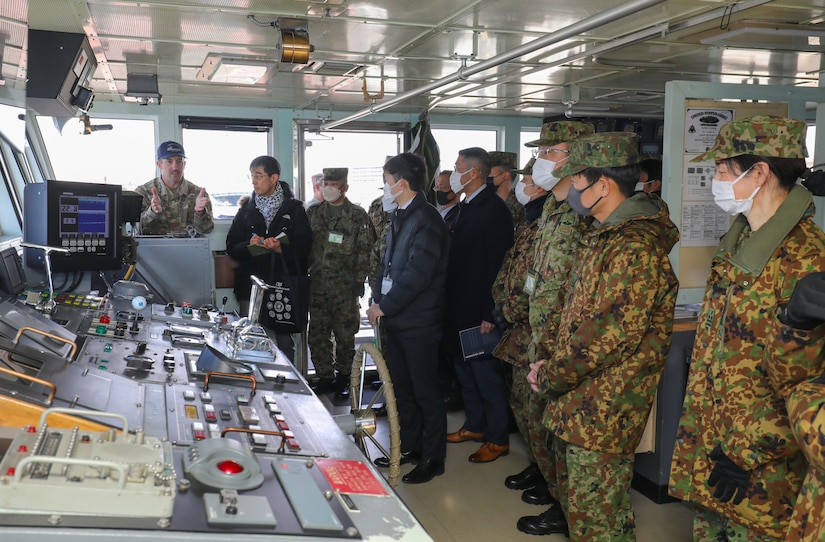 Chief Warrant Officer 2 Jason McElrath, left, vessel master of LCU Calaboza, briefs a group of Japan Ground Self-Defense Force leaders during a tour of the U.S. Army landing craft utility vessel at Yokohama North Dock, Japan, Jan. 25, 2023. (U.S. Army photo by Sean Kimmons)