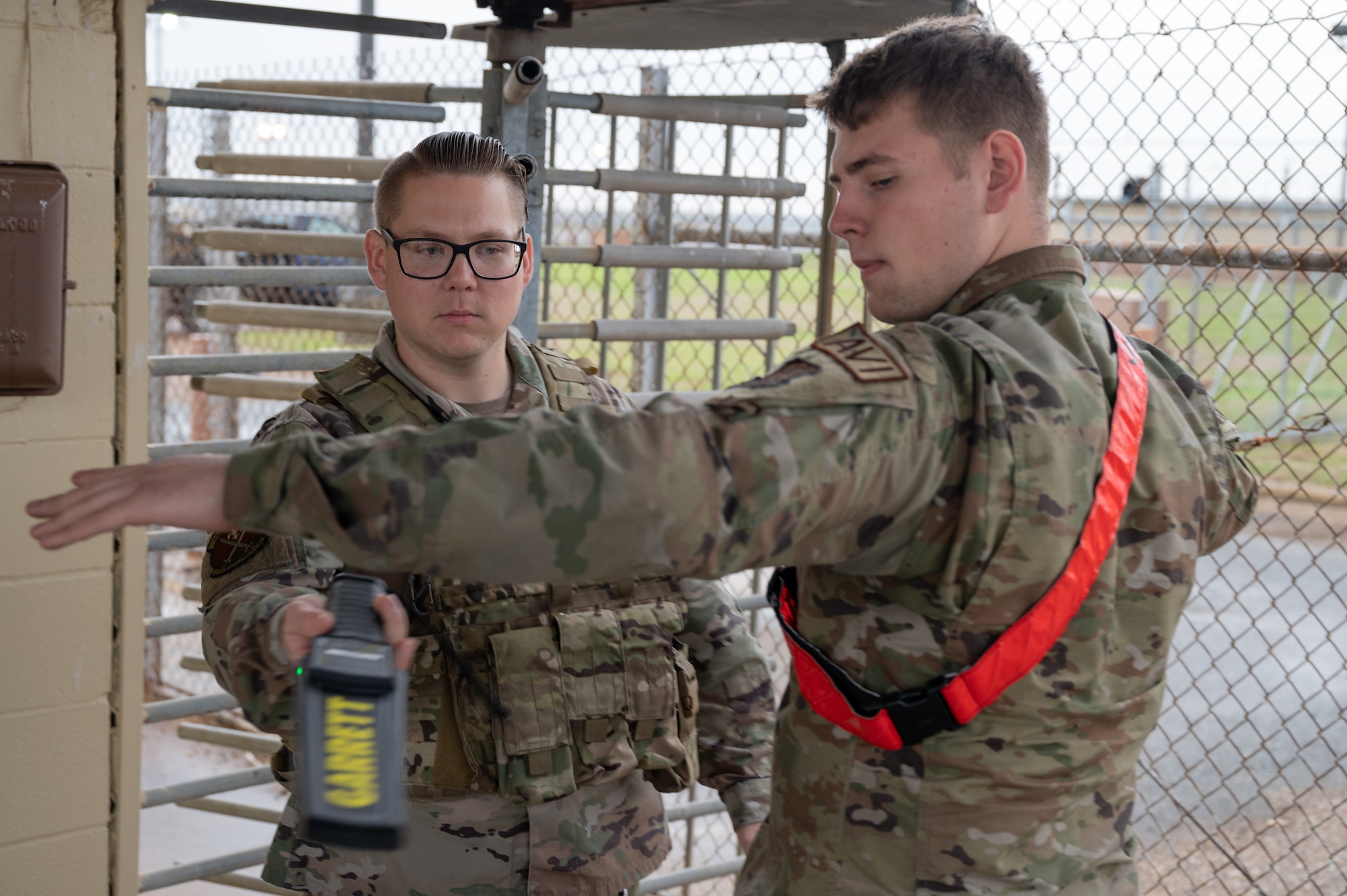 Tech. Sgt. Richard Holbrook, 2nd Security Forces Squadron kennel master, uses a Garrett hand-held metal detector to scan a Barksdale Airman during exercise Bayou Vigilance at Barksdale Air Force Base, La., Jan. 18, 2023.