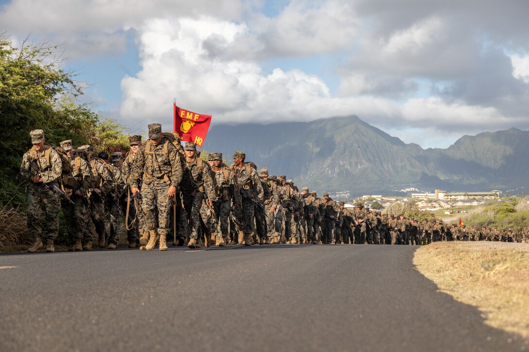 MARINE CORPS BASE HAWAII (Aug. 12, 2022) U.S. Marines with 3d Marine Littoral Regiment Headquarters, 3d Marine Division, hike in formation during a sustainment 10-kilometer hike at Marine Corps Base Hawaii, Aug. 12, 2022. Sustaining physical and mental fitness ensures the 3d MLR continues to stay dedicated to future warfighting. (U.S. Marine Corps photo by Sgt. Israel Chincio)