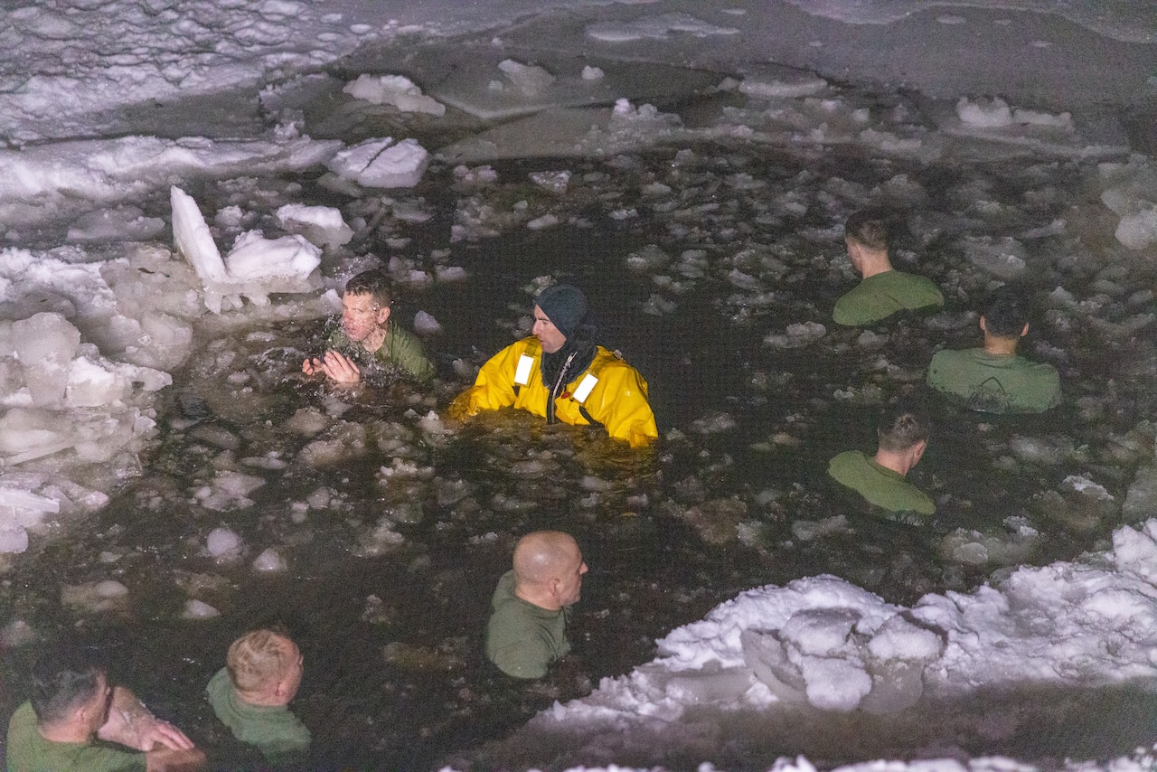 Marines float in icy water.