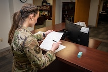 U.S. Air Force Senior Airman Jessica Ramsay, 5th Bomb Wing Legal Office civil law paralegal, notarizes a document for an Airman at Minot Air Force Base, North Dakota, Jan. 24, 2023. She was one of two Airmen selected by Gen. Anthony J. Cotton, the previous commander of Air Force Global Strike Command, for a spot in the Senior Leader Enlisted Commissioning Program. (U.S. Air Force photo by Airman 1st Class Alexander Nottingham)