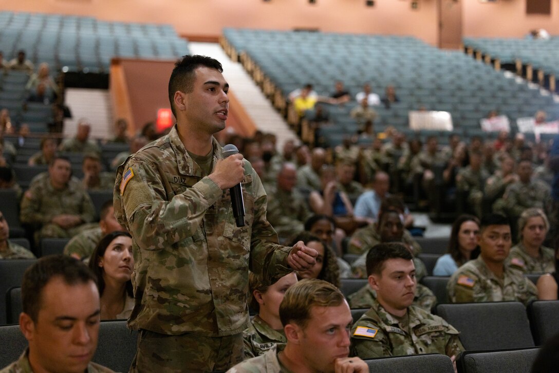 A U.S. Army Soldier from the 25th Infantry Division, asks the Honorable Christine E. Wormuth, 25th Secretary of the Army, a question during a town hall at Sgt. Smith Theatre, Schofield Barracks, Hawaii, Jan. 24, 2023. During the town hall, Wormuth addressed questions and concerns from Soldiers, family members and Department of the Army civilians from across the island. (U.S. Army photo by Sgt. Rachel Christensen/28th Public Affairs Detachment)