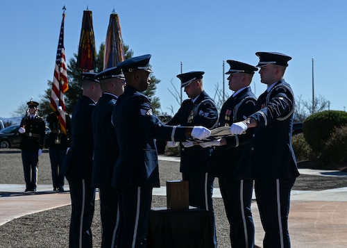 Members of the U.S. Air Force Honor Guard fold the American flag during retired Chief Master Sgt. Paul Kerchum’s interment ceremony at Southern Arizona Memorial Veterans Cemetery, Sierra Vista, Ariz., Jan. 25, 2023. Kerchum died Dec. 17, 2022, and was laid to rest with full military honors on what would have been his 103rd birthday. He was a World War II POW and the last survivor of the 65-mile Bataan Death March in the Philippine Islands. (U.S. Air Force photo by Airman 1st Class Paige Weldon)