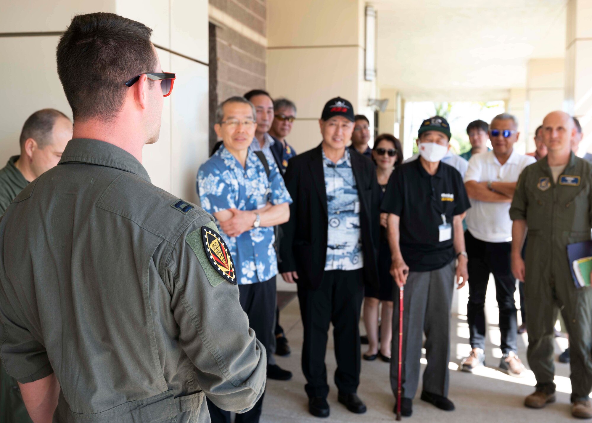 Photo of Japan Defense Society Members being briefed by a U.S. Air Force service member.