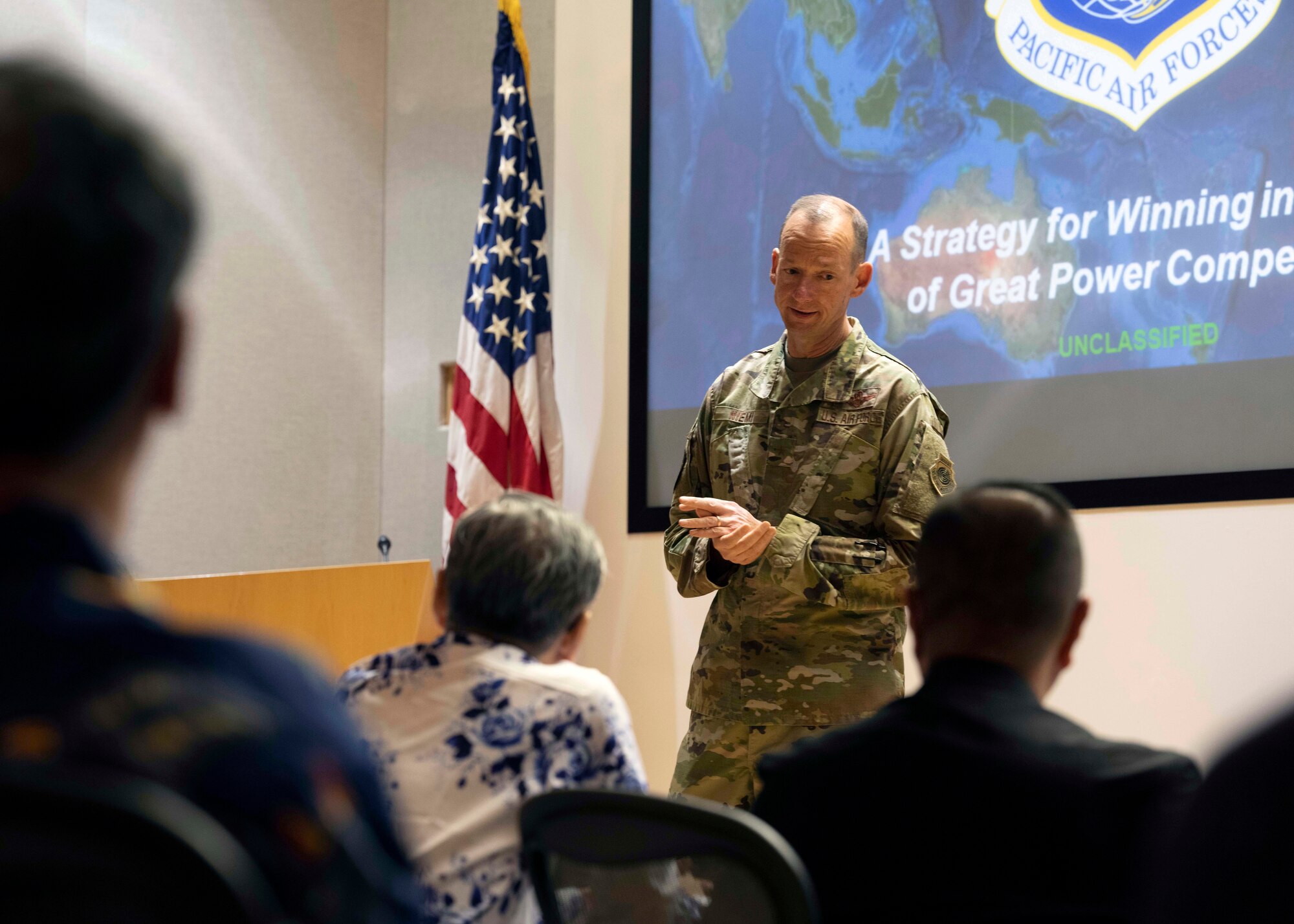 Photo of Japan Defense Society members being briefed by a U.S. Air Force service member.