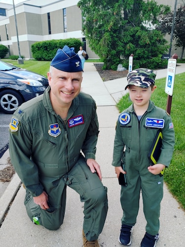 Colonel Jason Anderson, Air Force Institute of Technology faculty member, stands by his son, Reeve, who wears a military outfit in support of his father in the Air Force. Reeve was assisted by Lt. Col. Cassandra Burns, 88th Medical Group pediatric neurologist, after being diagnosed with a rare case of cerebral folate deficiency at four years old, along with being diagnosed with down syndrome at birth. (Courtesy Photo)