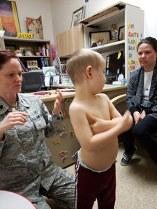 Lt. Col. Cassandra Burns (left), 88th Medical Group pediatric neurologist, examines Reeve and discusses details regarding his medical symptoms with his mother, Shana Anderson (right) at Wright-Patterson Air Force Base, Ohio. Reeve was assisted by Lt. Col. Cassandra Burns, 88th Medical Group pediatric neurologist, after being diagnosed with a rare case of cerebral folate deficiency at four years old, along with being diagnosed with down syndrome at birth. (Courtesy Photo)