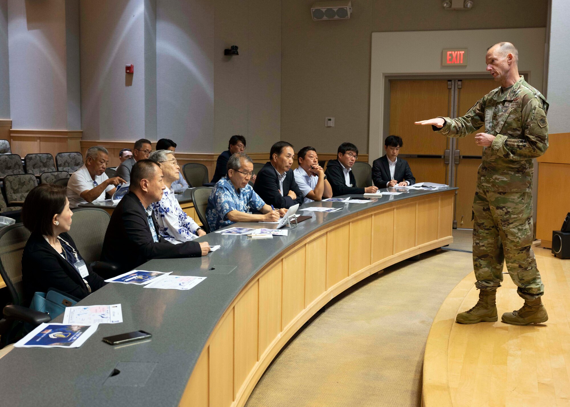 Photo of Japan Defense Society members being briefed by a U.S. Air Force service member.