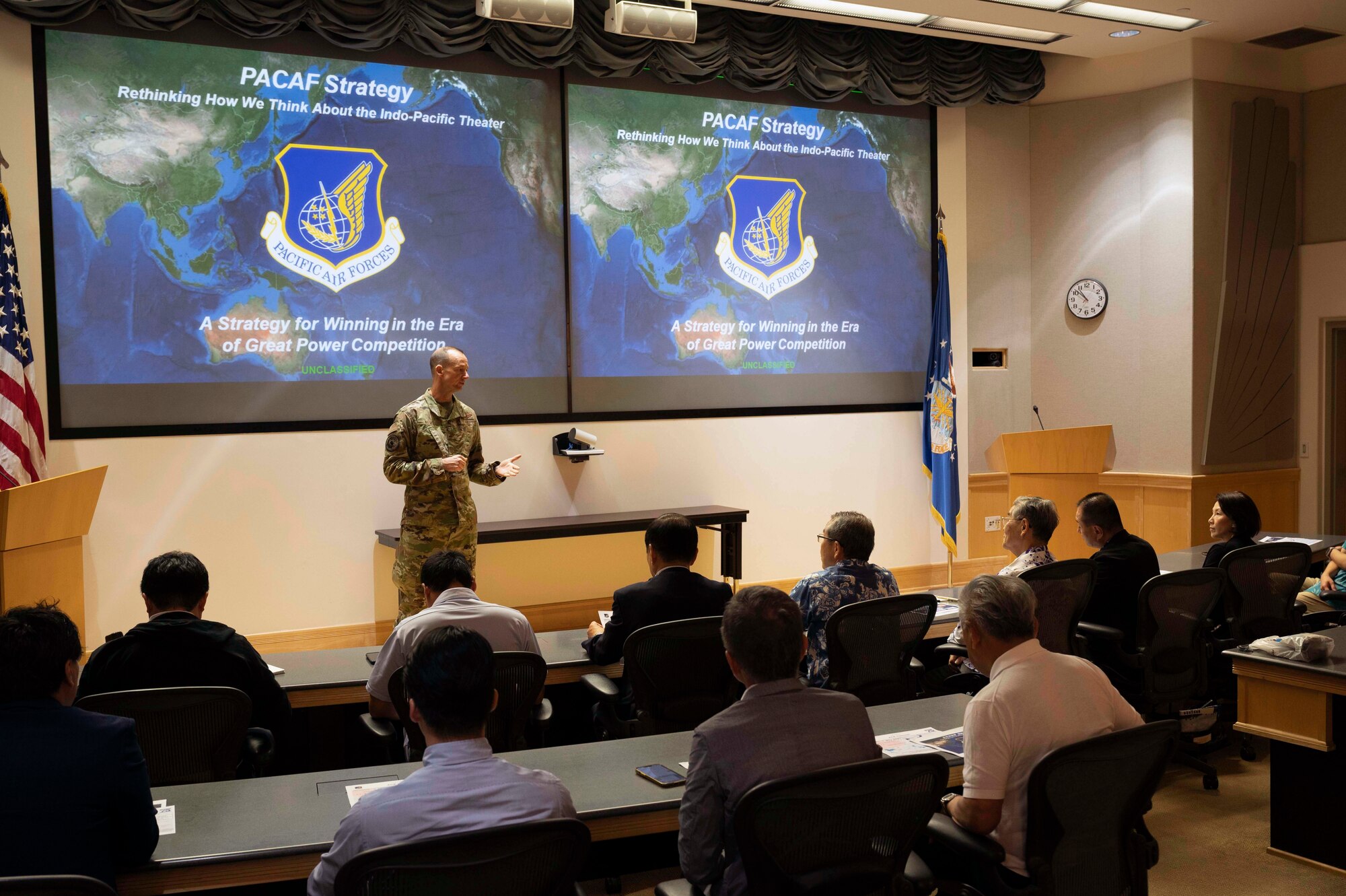 Photo of Japan Defense Society members being briefed by a U.S. Air Force service member.