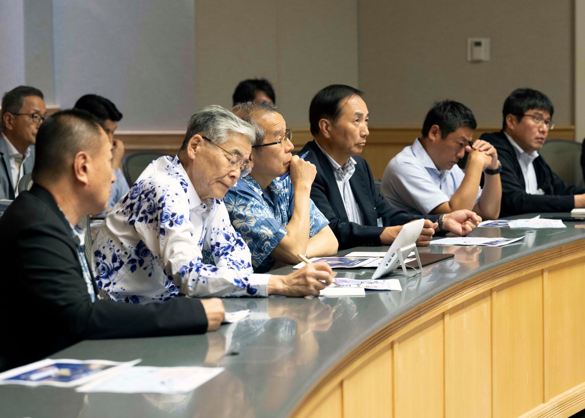 Photo of Japan Defense Society members being briefed by a U.S. Air Force service member.