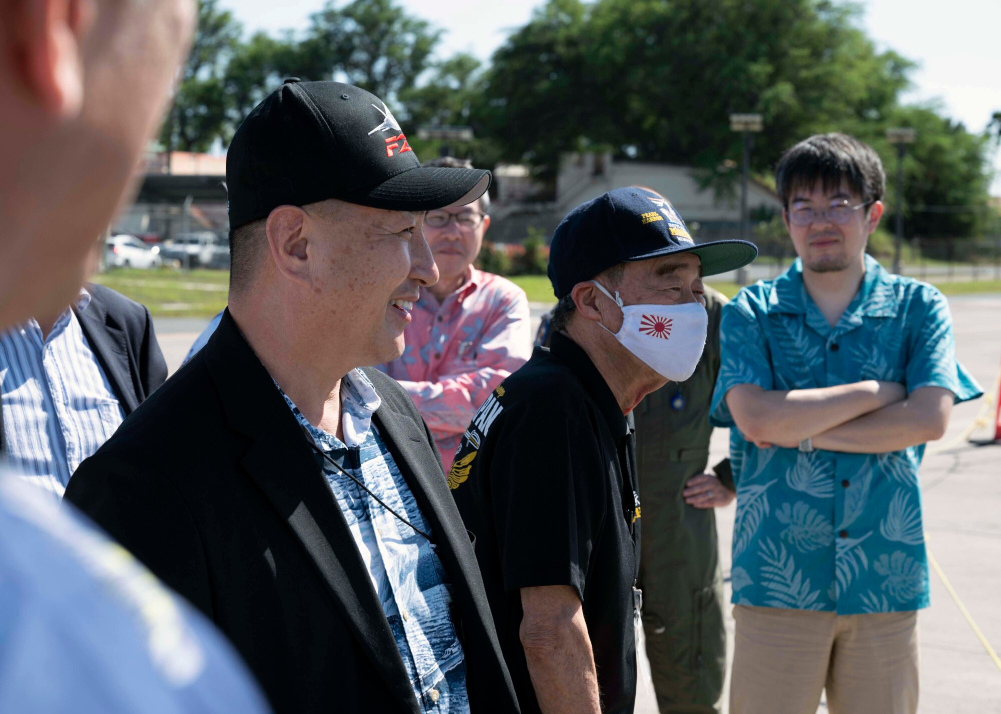 Photo of Japan Defense Society members examining an aircraft