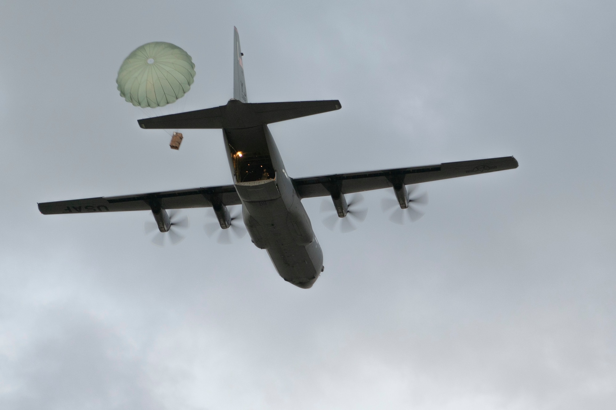 A U.S. Air Force C-130J Super Hercules makes an airdrop as a part of a training exercise over Pacific Regional Training Center, Andersen Air Force Base, Guam Jan. 19, 2023. The 36th Contingency Response Squadron conducted a training exercise to set up a drop zone while the C-130J Super Hercules crew aimed to put the drops on target. (U.S. Air Force photo by Airman 1st Class Spencer Perkins)