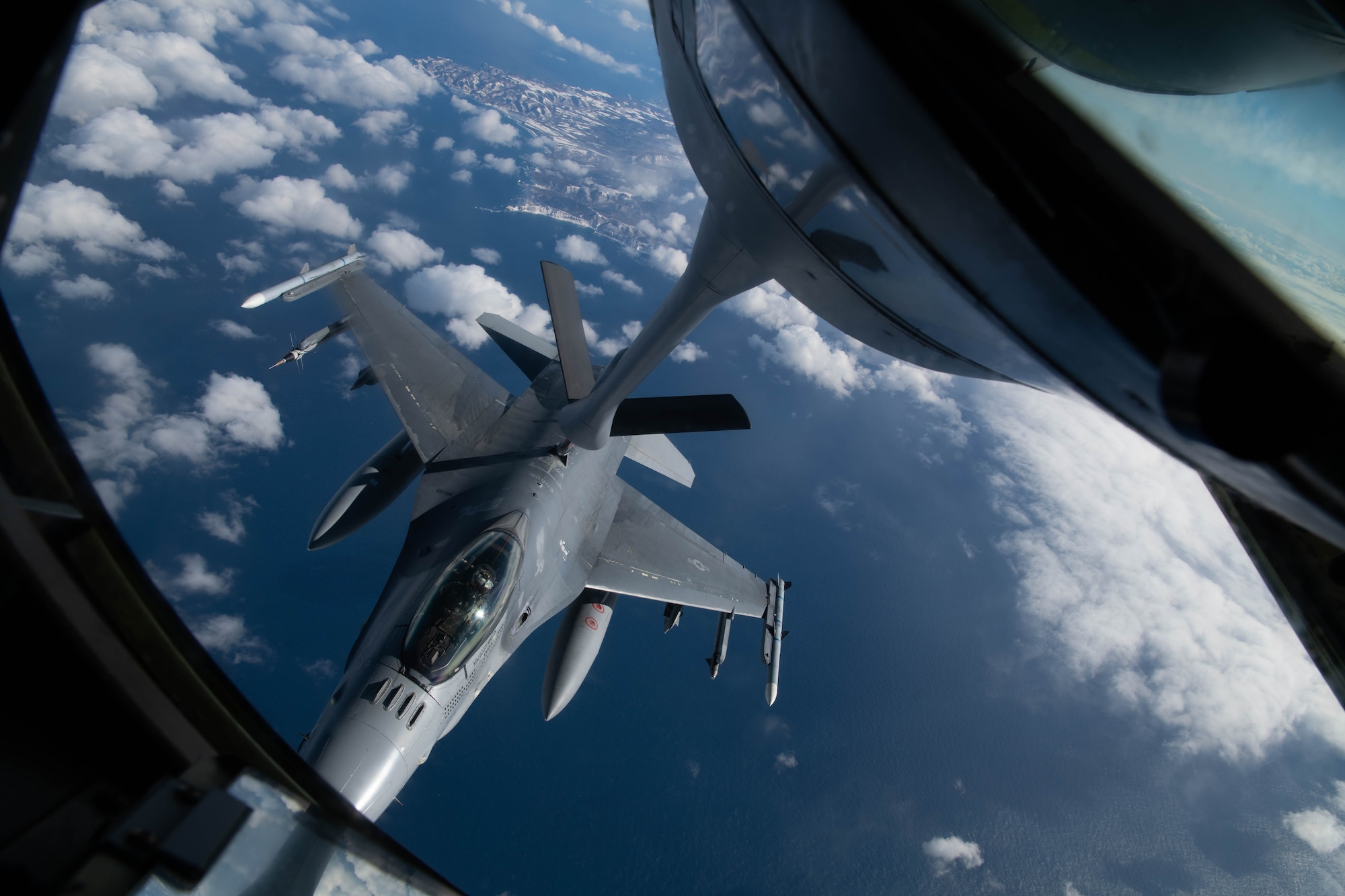 An aircraft conducts aerial refueling.