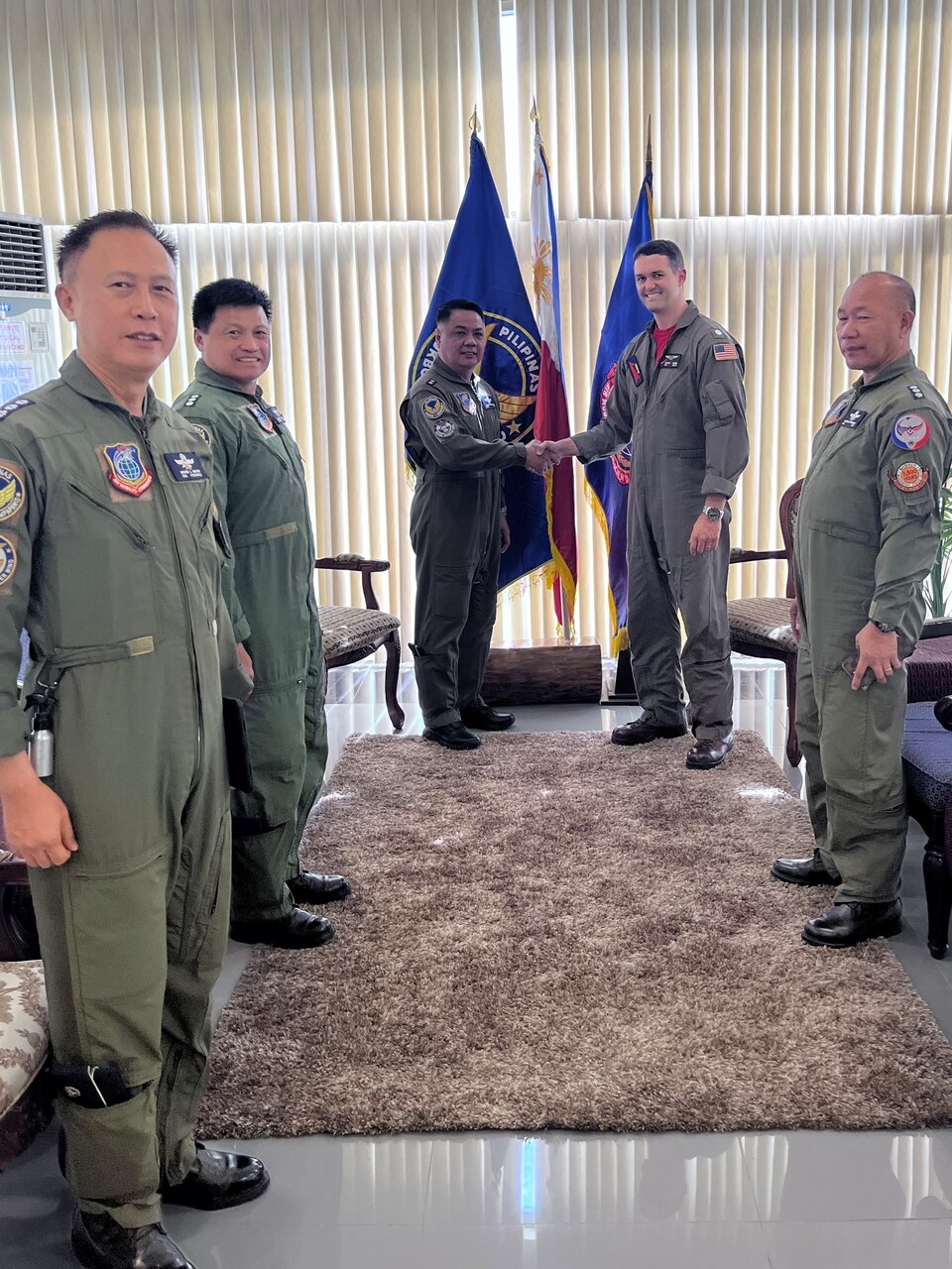 Maj. Gen. Joannis Leonardi B. Dimaano, commander, Air Mobility Command, and Cmdr. Marc Hines, commanding officer of the “Red Lancers” of Patrol Squadron (VP) 10, shake hands during a meeting as part of a weeklong engagement promoting joint regional security and partnerships out of Mactan, Philippines. VP-10 is based in Jacksonville, Florida and is currently operating from Kadena Air Base in Okinawa, Japan. It conducts maritime patrol and reconnaissance, as well as theater outreach operations, as part of a rotational deployment to the U.S. 7th Fleet area of operations. (U.S. Navy photo by Lt. j.g. Travis Goebel)