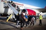 Passengers board an airplane