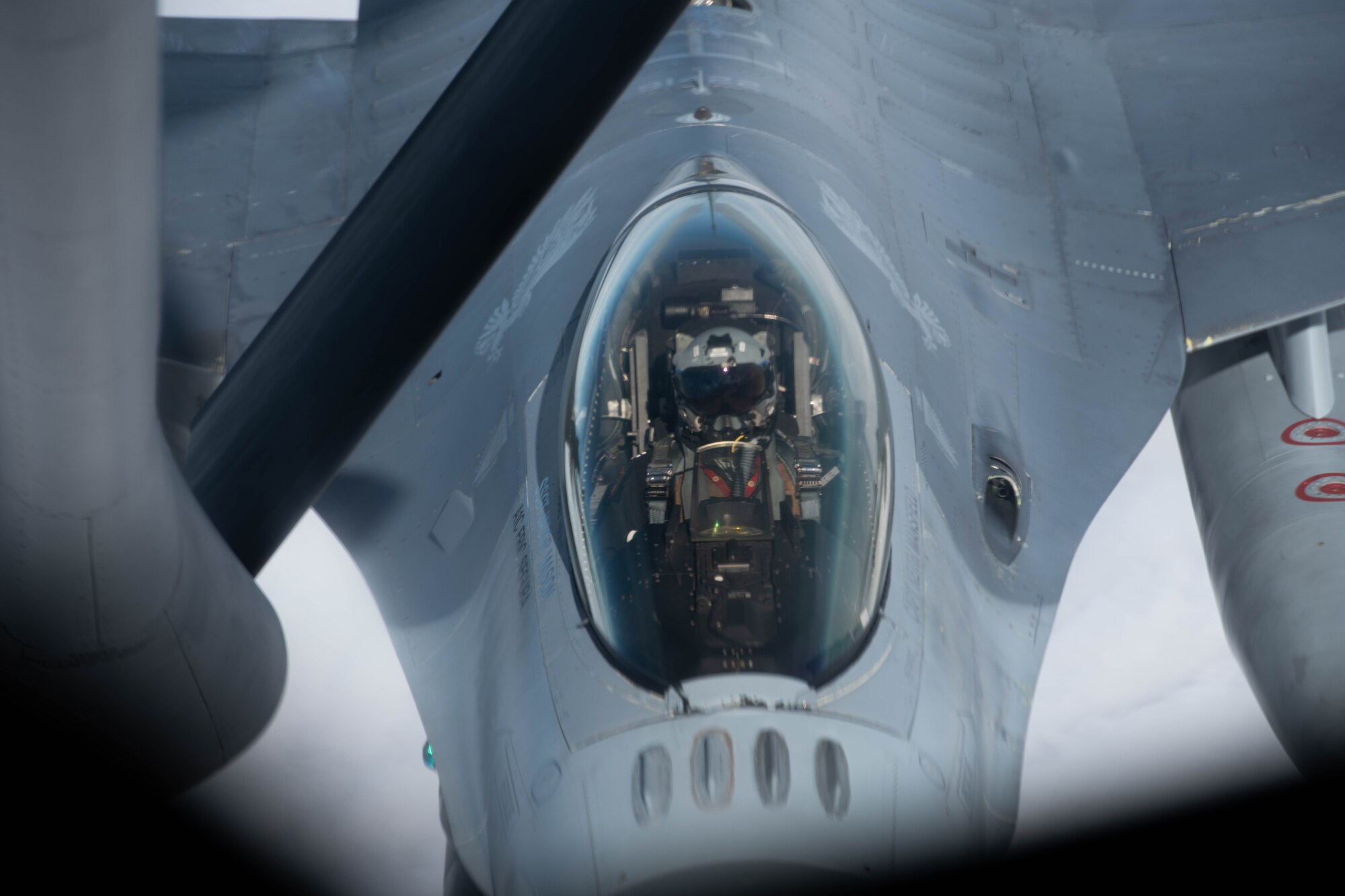 An aircraft conducts aerial refueling.