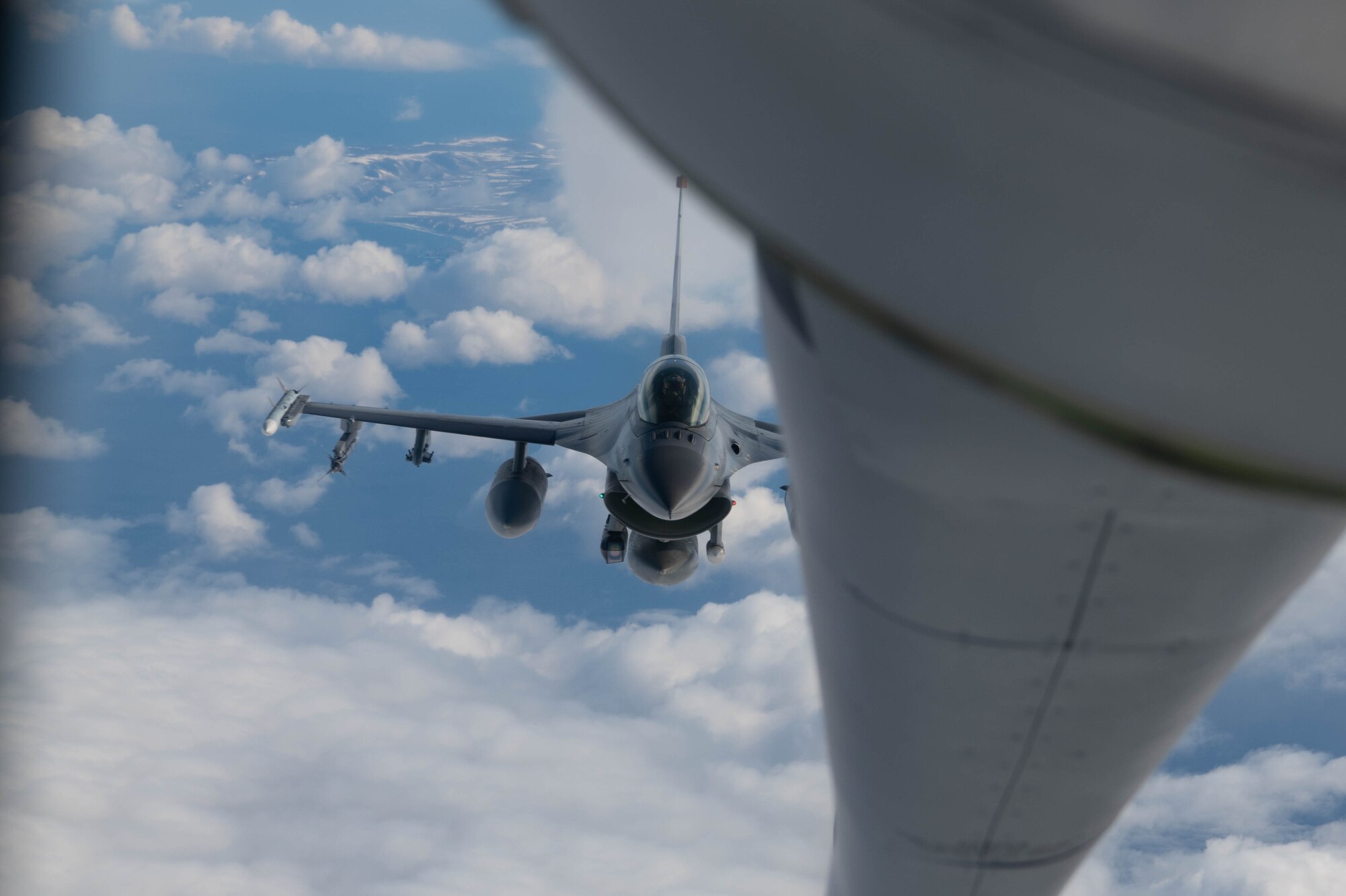 An aircraft conducts aerial refueling.