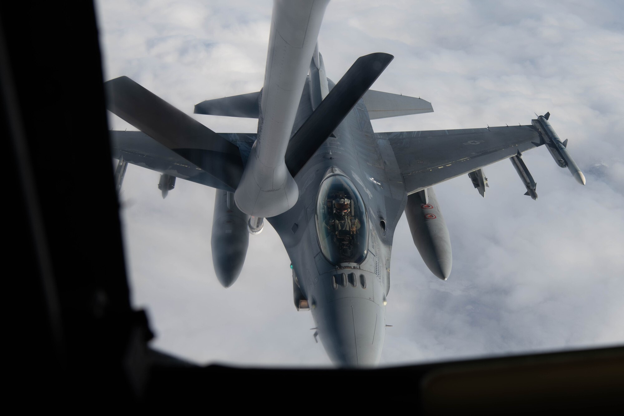 An aircraft conducts aerial refueling.