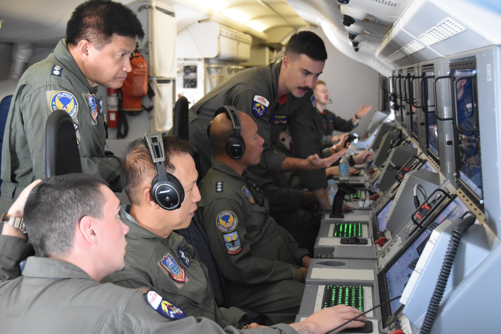 Naval Aircrewman (operator) 2nd Class William Pottenger (top) and Naval Aircrewman (operator) 3rd Class Justin Fruci, both assigned to the “Red Lancers” of Patrol Squadron (VP) 10, explain mission work stations during a tour of a P-8A Poseidon as part of a weeklong engagement promoting joint regional security and partnerships out of Mactan, Philippines. VP-10 is based in Jacksonville, Florida and is currently operating from Kadena Air Base in Okinawa, Japan. It conducts maritime patrol and reconnaissance, as well as theater outreach operations, as part of a rotational deployment to the U.S. 7th Fleet area of operations. (U.S. Navy photo by Lt. j.g. Travis Goebel)