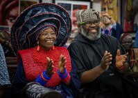230129-N-DK722-1007 (Jan. 29, 2023) LAGOS, Nigeria -- Chief Dr. Nike Davies-Okundaye, left, and Jesse King Buga applaud during a performance by the Maritime Winds of the U.S. Naval Forces Europe-Africa Band at the Nike Art Foundation in Lagos, Nigeria, Jan. 29, 2023, during exercise Obangame Express 2023. Obangame Express 2023, conducted by U.S. Naval Forces Africa, is a maritime exercise designed to improve cooperation, and increase maritime safety and security among participating nations in the Gulf of Guinea and Southern Atlantic Ocean. U.S. Sixth Fleet, headquartered in Naples, Italy, conducts the full spectrum of joint and naval operations, often in concert with allied and interagency partners, in order to advance U.S. national interests and security and stability in Europe and Africa. (U.S. Navy photo by Mass Communication Specialist 1st class Cameron C. Edy)