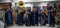 230129-N-DK722-1008 (Jan. 29, 2023) LAGOS, Nigeria -- The Topside Brass Band of the U.S. Naval Forces Europe-Africa Band, while wearing traditional Nigerian garments, perform at the Nike Art Foundation in Lagos, Nigeria, Jan. 29, 2023, during exercise Obangame Express 2023. Obangame Express 2023, conducted by U.S. Naval Forces Africa, is a maritime exercise designed to improve cooperation, and increase maritime safety and security among participating nations in the Gulf of Guinea and Southern Atlantic Ocean. U.S. Sixth Fleet, headquartered in Naples, Italy, conducts the full spectrum of joint and naval operations, often in concert with allied and interagency partners, in order to advance U.S. national interests and security and stability in Europe and Africa. (U.S. Navy photo by Mass Communication Specialist 1st class Cameron C. Edy)