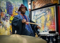 230129-N-DK722-1010 (Jan. 29, 2023) LAGOS, Nigeria -- Musician 2nd Class Michael Wallace, while wearing traditional Nigerian garments, plays the drums during a performance by the U.S. Naval Forces Europe-Africa Band at the Nike Art Foundation in Lagos, Nigeria, Jan. 29, 2023, during exercise Obangame Express 2023. Obangame Express 2023, conducted by U.S. Naval Forces Africa, is a maritime exercise designed to improve cooperation, and increase maritime safety and security among participating nations in the Gulf of Guinea and Southern Atlantic Ocean. U.S. Sixth Fleet, headquartered in Naples, Italy, conducts the full spectrum of joint and naval operations, often in concert with allied and interagency partners, in order to advance U.S. national interests and security and stability in Europe and Africa. (U.S. Navy photo by Mass Communication Specialist 1st class Cameron C. Edy)