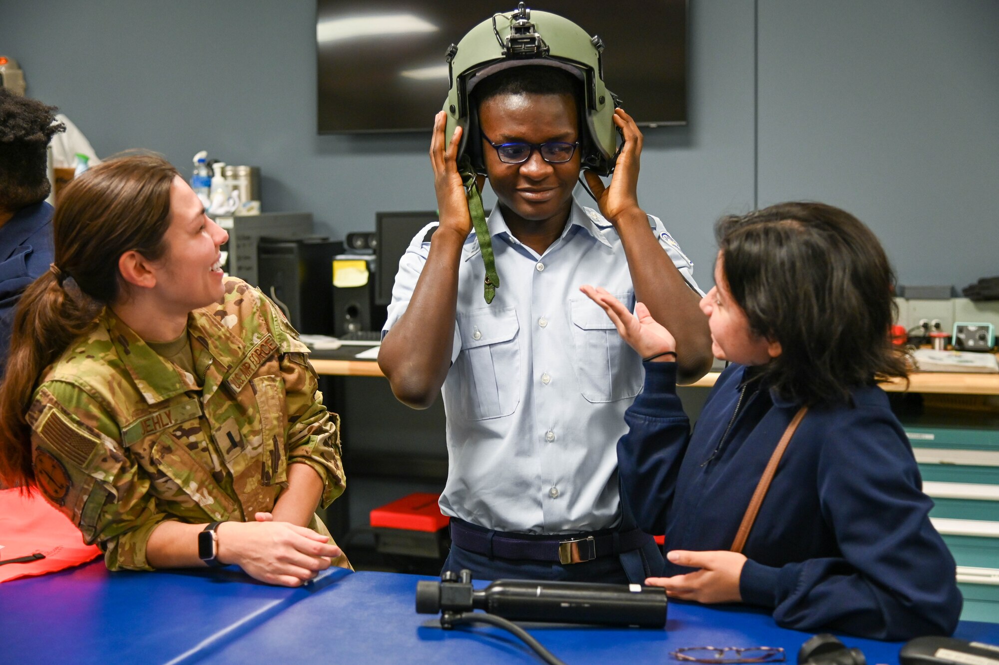 Student in uniform tries on helmet