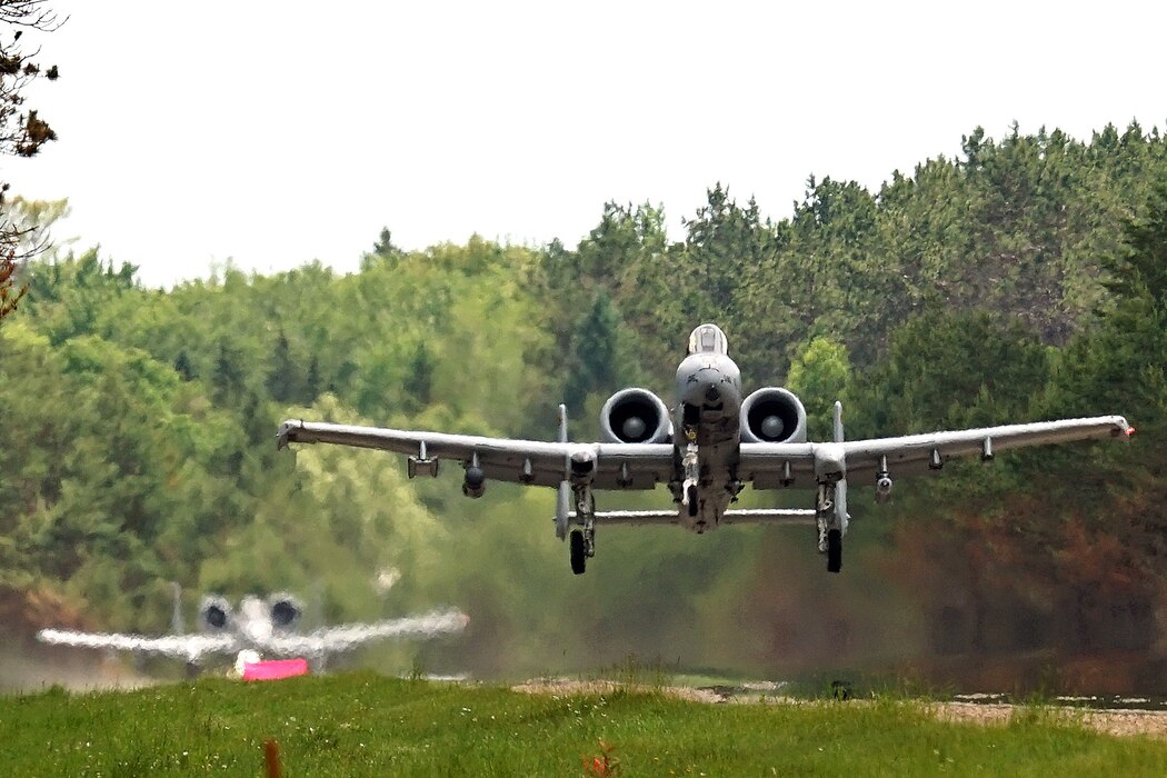 An A-10 Thunderbolt II from the 107th Fighter Squadron, 127th Wing, Michigan Air National Guard (ANG), lands and takes off from a highway during Agile Combat Employment (ACE) training during Northern Agility-1 22 in Alger County, located in the Upper Peninsula of Mich., June 29, 2022. The Northern Agility exercise series exemplifies the MI ANG’s progressive vision for fighter forward arming and refueling training that will land aircraft in an austere landing zone, continuing to champion ACE and adaptive basing concepts for the U.S. Air Force. ACE not only requires novel equipment, but also innovative Airmen that can support the Multi-Capable Airmen (MCA) concept. (U.S. Air National Guard photo by Master Sgt. David Kujawa)